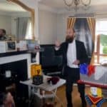 Magician performing show at childs's birthday party