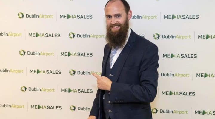 Magician in front of Dublin Airport signboard at corporate event
